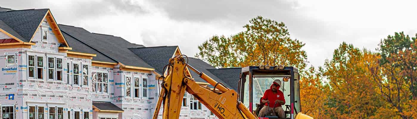 New home construction site with framed houses in a growing community